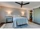 Bright main bedroom with a ceiling fan, neutral walls, stylish rug and two side tables with lamps at 1510 Dominion Dr, Zionsville, IN 46077