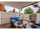 Inviting covered patio featuring cozy seating arrangements, decorative wall art, and a wooden deck, creating a relaxing atmosphere at 1510 Dominion Dr, Zionsville, IN 46077