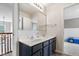 Bright bathroom with a double vanity, large mirrors and modern lighting at 15515 Alameda Pl, Westfield, IN 46074