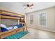 Fun ' bedroom featuring a wooden bunk bed, sports-themed decor, and bright windows for a cheerful atmosphere at 15515 Alameda Pl, Westfield, IN 46074