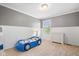 Playful room features a car-shaped bed, neutral carpet, and white wainscoting, creating a fun, cozy space at 15515 Alameda Pl, Westfield, IN 46074