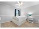 Cozy bedroom with a white bed frame, a small nightstand, a ceiling fan, and neutral walls and carpeting at 15515 Alameda Pl, Westfield, IN 46074