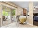 Sunlit breakfast nook showcases a table with seating, sliding glass doors to a screened-in porch, and access to the living room at 15515 Alameda Pl, Westfield, IN 46074