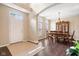 Inviting foyer leading to a dining room with hardwood floors, a chandelier, and a china cabinet at 15515 Alameda Pl, Westfield, IN 46074