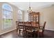Elegant dining room with hardwood floors, large windows, chandelier, and classic wooden furniture at 15515 Alameda Pl, Westfield, IN 46074