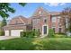 Beautiful two-story brick home featuring a well-manicured lawn and a two-car garage at 15515 Alameda Pl, Westfield, IN 46074
