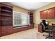Well-lit home office with custom built-in bookshelves, cabinets, and a window seat providing ample storage and natural light at 15515 Alameda Pl, Westfield, IN 46074