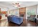 Spacious living room featuring a fireplace, hardwood floors, and a view into the kitchen at 15515 Alameda Pl, Westfield, IN 46074