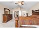 This main bedroom features a bed, carpet, ceiling fan, and access to the Primary bath and walk-in closet at 15515 Alameda Pl, Westfield, IN 46074