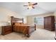 Spacious main bedroom with a ceiling fan, large bed, carpet, and windows, plus wooden wardrobe and nightstands at 15515 Alameda Pl, Westfield, IN 46074
