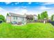Spacious backyard featuring a fire pit with seating, lush green lawn, and a play area for  at 1630 Eastfork Dr, Brownsburg, IN 46112