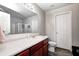 Well-lit bathroom with dark wood cabinets, a white sink, and glass enclosed shower at 1630 Eastfork Dr, Brownsburg, IN 46112