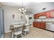 Dining area with modern table set, stylish light fixture, and adjacent cherry cabinetry at 1630 Eastfork Dr, Brownsburg, IN 46112