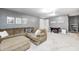Open living room with sectional couch, plush carpet, and game time wall art at 1630 Eastfork Dr, Brownsburg, IN 46112