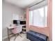 Comfortable home office with white desk, accent chair, shelving, and natural light at 1630 Eastfork Dr, Brownsburg, IN 46112