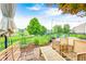 Charming brick patio featuring outdoor seating, mature trees, and a view of the pond at 1630 Eastfork Dr, Brownsburg, IN 46112