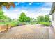 Beautiful brick patio with string lights, seating, and a view of the pond and backyard at 1630 Eastfork Dr, Brownsburg, IN 46112