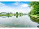 Scenic view of the community pond surrounded by lush greenery and trees at 1630 Eastfork Dr, Brownsburg, IN 46112