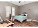 Cozy bedroom with two windows and wood-look flooring at 1635 N College Ave # 4, Indianapolis, IN 46202