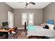 Bedroom with ceiling fan, two windows, wood-look flooring and desk at 1635 N College Ave # 4, Indianapolis, IN 46202