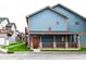 Charming blue two-story home with inviting porch and stone accents. Houses in the distance at 1635 N College Ave # 4, Indianapolis, IN 46202