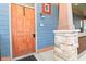 Inviting front entrance with a wooden door and a stone support post at 1635 N College Ave # 4, Indianapolis, IN 46202