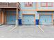 Three garages with ample parking space and blue doors and trash cans at 1635 N College Ave # 4, Indianapolis, IN 46202