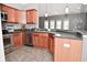 Updated kitchen featuring wooden cabinets, stainless steel appliances, and open floor plan at 1635 N College Ave # 4, Indianapolis, IN 46202