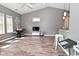 Open living space with views of the kitchen, bright windows, and wood-look floors at 1635 N College Ave # 4, Indianapolis, IN 46202