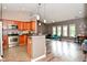 Open concept living room and kitchen with pendant lighting, high ceilings, and modern finishes at 1635 N College Ave # 4, Indianapolis, IN 46202