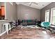 Open living space with a cozy sofa, large windows, and laminate wood flooring at 1635 N College Ave # 4, Indianapolis, IN 46202