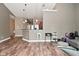 Spacious living area featuring an open floor plan, wood-look flooring, and modern lighting at 1635 N College Ave # 4, Indianapolis, IN 46202