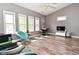Bright living room features stylish decor, ample natural light, and wood-look flooring at 1635 N College Ave # 4, Indianapolis, IN 46202