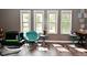 Inviting living room with natural light streaming through large windows and laminate wood flooring at 1635 N College Ave # 4, Indianapolis, IN 46202