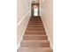 Carpeted staircase leading upstairs with white banister and natural light at 1635 N College Ave # 4, Indianapolis, IN 46202