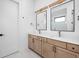 Bathroom with double vanity, quartz countertop, wood cabinets, and modern fixtures at 1663 Fernley Dr, Westfield, IN 46074