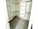 Walk-in closet with custom shelving and neutral carpeting at 1663 Fernley Dr, Westfield, IN 46074