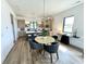 Stylish dining area with modern light fixture, and open view of the kitchen space at 1663 Fernley Dr, Westfield, IN 46074