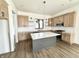 Modern kitchen featuring granite countertops, stainless steel appliances, grey island, and hardwood flooring at 1663 Fernley Dr, Westfield, IN 46074