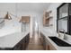 Modern kitchen island with a view into the living room space with hardwood floors at 1663 Fernley Dr, Westfield, IN 46074