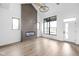 Bright living room with vaulted ceilings, sleek fireplace, wood floors, and large windows at 1663 Fernley Dr, Westfield, IN 46074