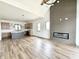 Open living space with hardwood floors, fireplace, modern light fixtures, and a modern kitchen at 1663 Fernley Dr, Westfield, IN 46074