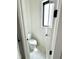 Powder room with white walls, tile flooring and a black framed window at 1663 Fernley Dr, Westfield, IN 46074
