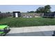 The spacious backyard features green grass, a playset, and a black shed at 1721 N Kaleigh Ln, Greensburg, IN 47240