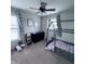 Bright bedroom features a ceiling fan, large windows, and a cozy house frame bed with colorful bedding at 1721 N Kaleigh Ln, Greensburg, IN 47240