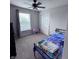Bright bedroom features neutral walls, carpeting, a ceiling fan, and an attached closet at 1721 N Kaleigh Ln, Greensburg, IN 47240