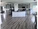 Open-concept kitchen with gray cabinets, granite countertops, stainless steel appliances, and hardwood floors at 1721 N Kaleigh Ln, Greensburg, IN 47240