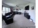 Bright living room featuring plush seating, a ceiling fan, and large windows for ample natural light at 1721 N Kaleigh Ln, Greensburg, IN 47240