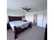 Relaxing main bedroom features a ceiling fan and a large window that fills the room with natural light at 1721 N Kaleigh Ln, Greensburg, IN 47240