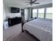 Relaxing main bedroom features a ceiling fan, a large window, and a sliding barn door to the bathroom at 1721 N Kaleigh Ln, Greensburg, IN 47240